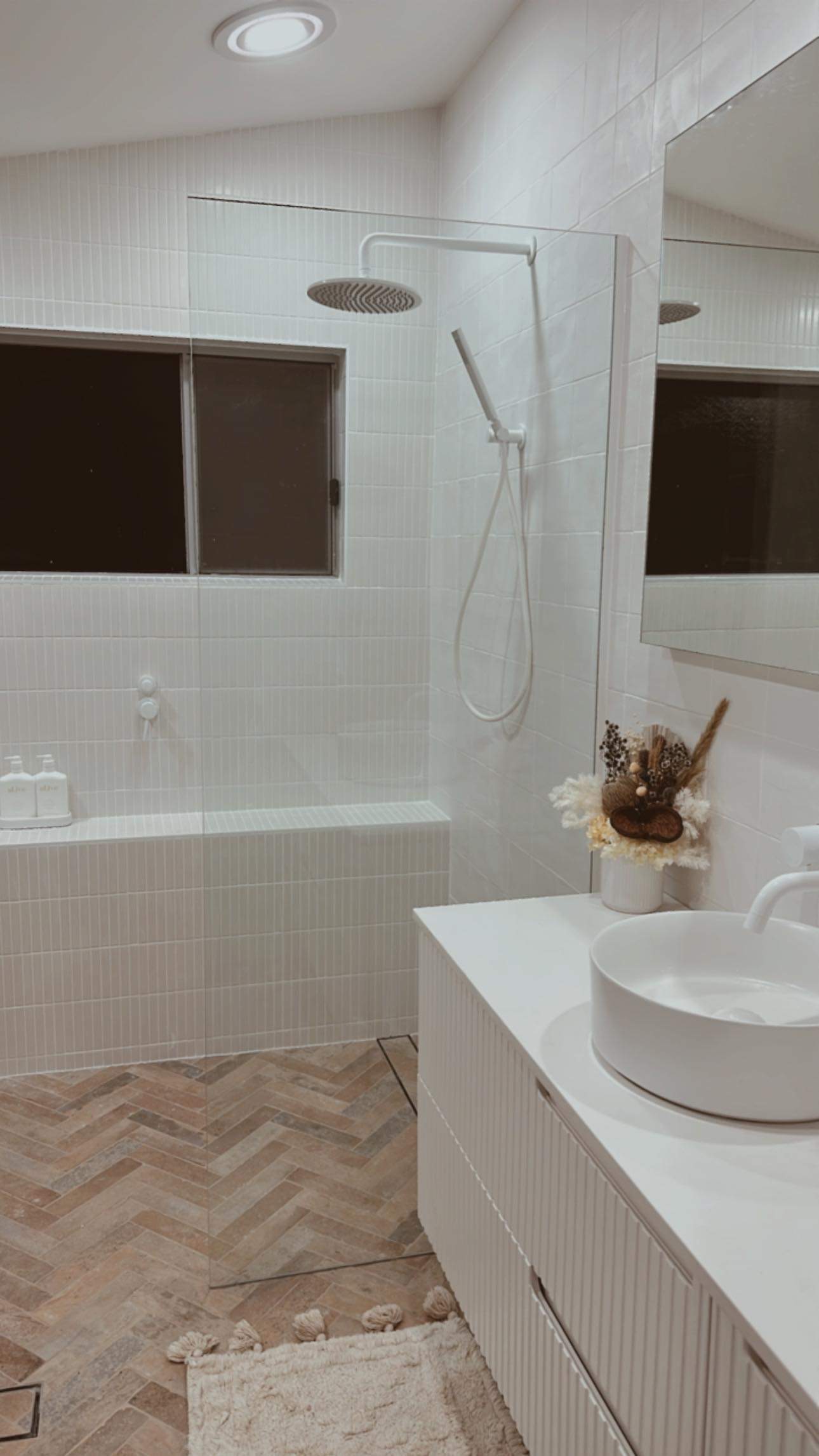 Herringbone bathroom tiling by East Coast Tiling
